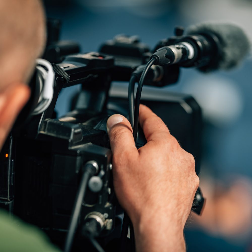 Live streaming. Camera at a press conference.